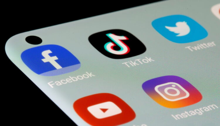 Facebook, TikTok, Twitter, YouTube and Instagram apps are seen on a smartphone in this illustration