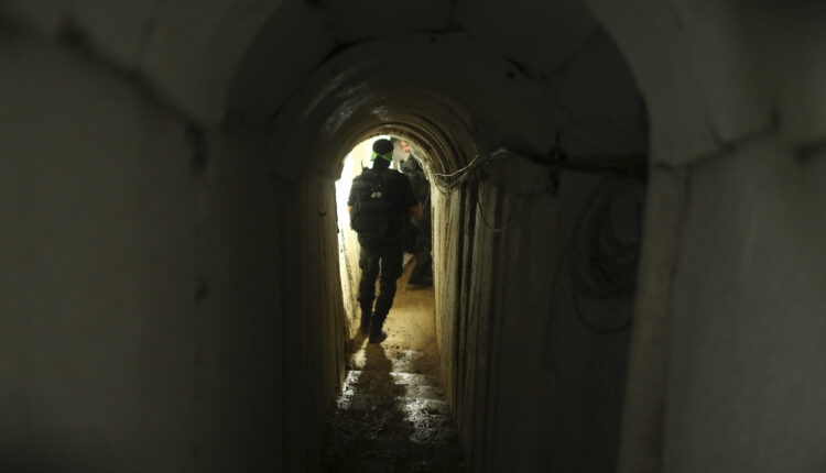 A Palestinian fighter from the Izz el-Deen al-Qassam Brigades, the armed wing of the Hamas movement, walks inside an underground tunnel in Gaza